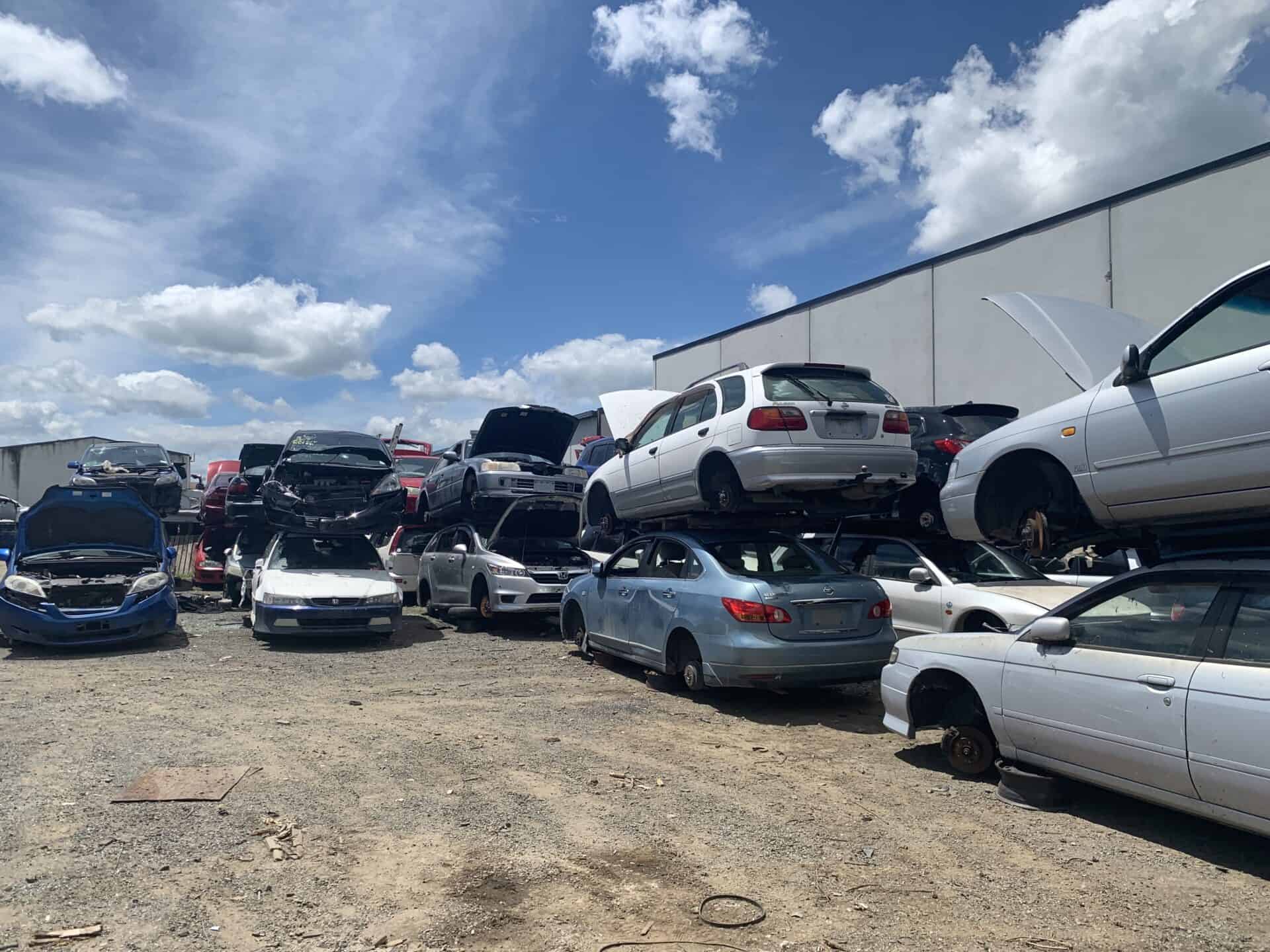 Large scrap yard in Hastings filled with old, damaged, and unwanted cars.